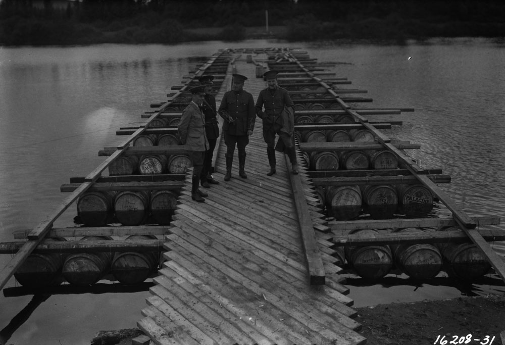 Photo of officers standing on floating bridge built by the army enginers